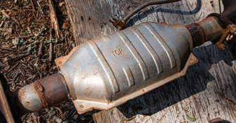 A catalytic converter laying on the ground.