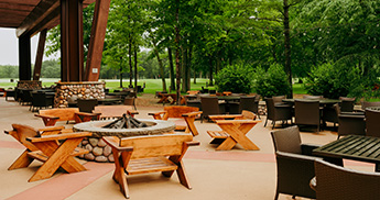 PJ's patio seating with golf course driving range behind.
