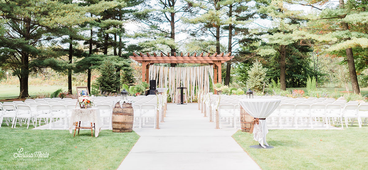 Rows of chairs and an alter for a wedding ceremony under the pergola at SentryWorld