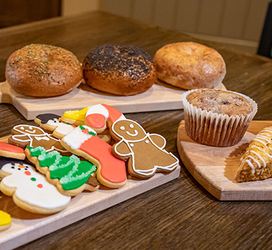 Holiday cookies and other bakery goods on wooden trays