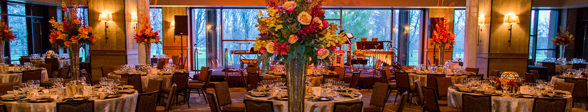 Tables set with floral decor in the Grand Hall at SentryWorld