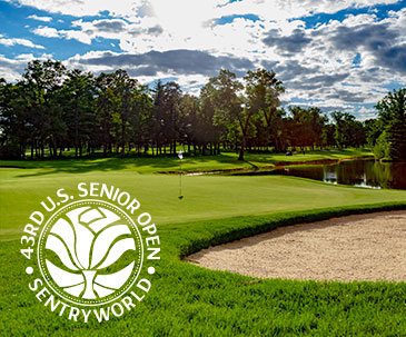 Putting green next to a water hazard and sand trap with the U.S. Senior Open at SentryWorld logo