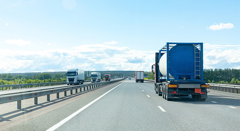 Semi trucks driving on a highway.