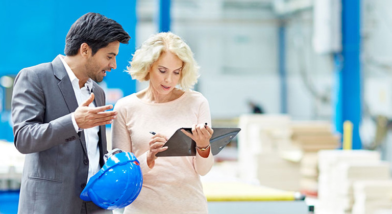 Man and woman talking in factory