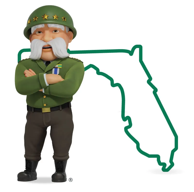 The General standing in front of Florida with his arms crossed and a smile.