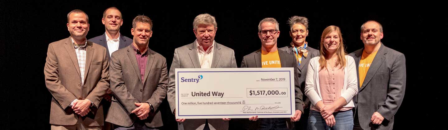 Pete McPartland representative for Sentry donates check to United Way