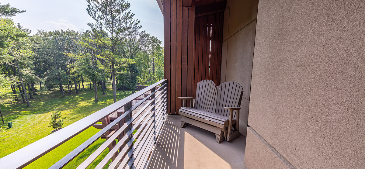 carousel-golf-view-executive-level-luxury-junior-suite-6-1200x556 Terrace area overlooking a golf course.