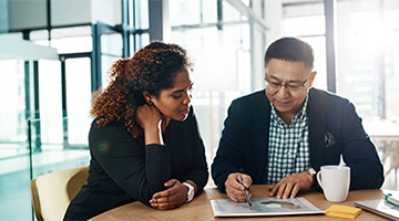 A man and a woman studying documents.