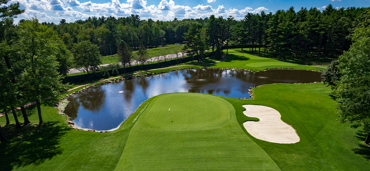 Water hazard and sand trap around a putting green at the SentryWorld golf course