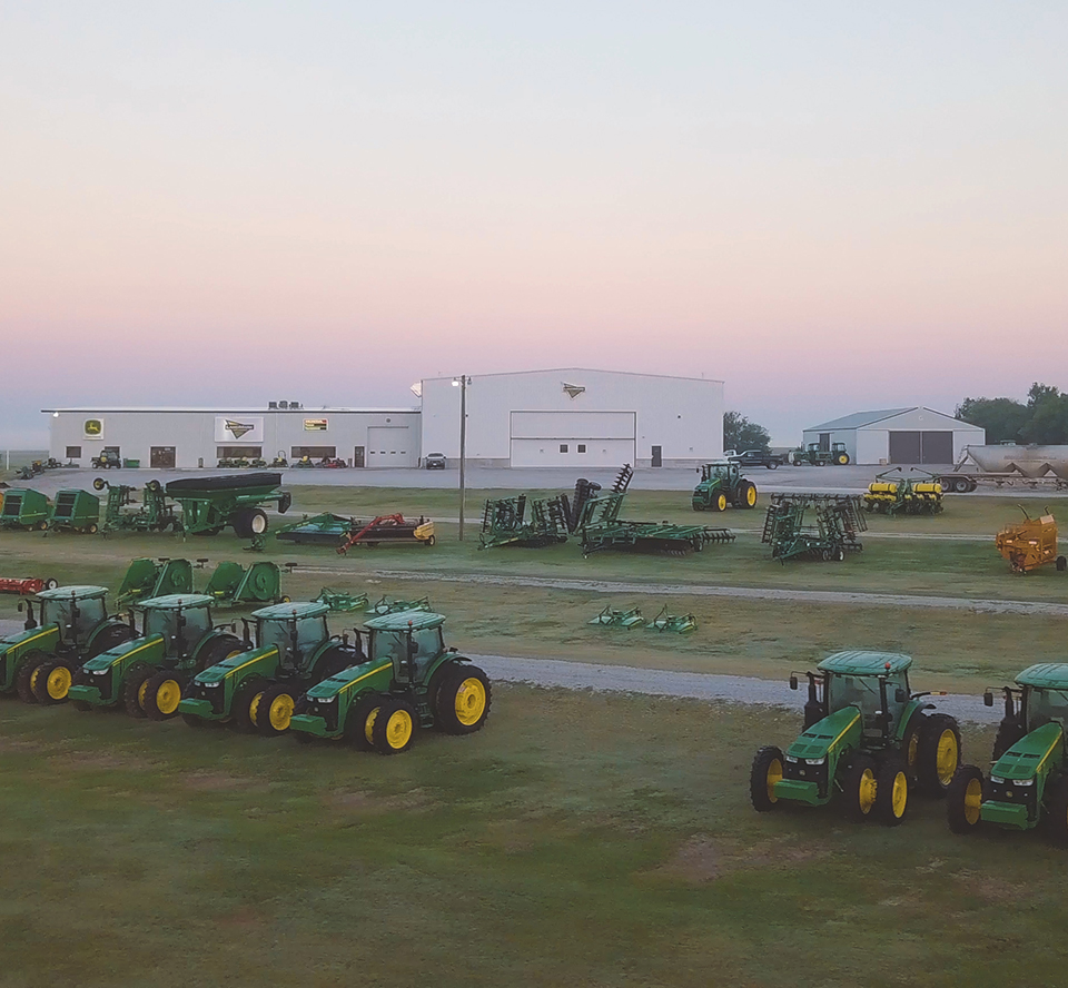 Farming equipment in work yard at dawn