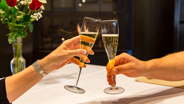 Two people toasting champagne glasses