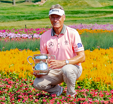 Bernhard Langer holding his 2023 U.S. Senior Open championship trophy.