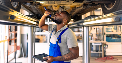 Mechanic looking under car.