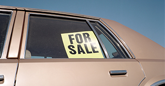 For Sale sign in the window of an older car