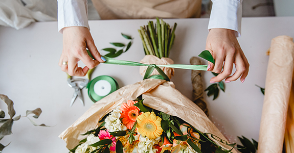 Worker tying up a flower bouquet