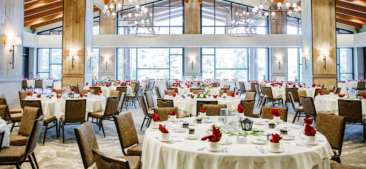 Round tables and chairs set for a wedding reception in the Grand Hall at SentryWorld