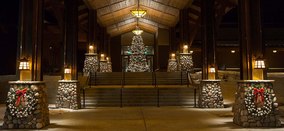 SentryWorld entrance at night with Christmas tree lit with white lights. 