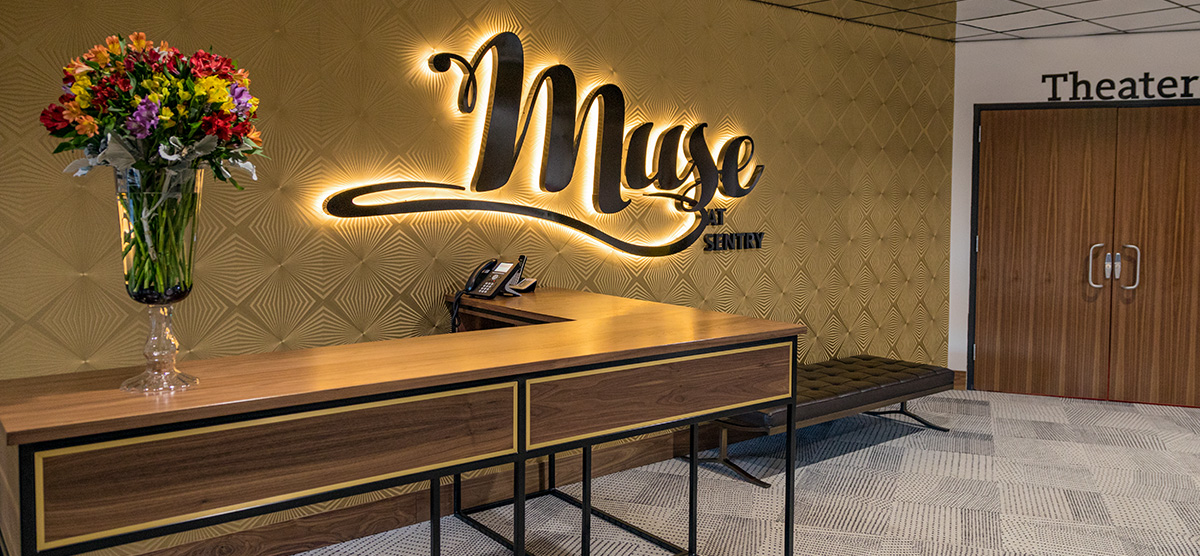 Muse at Sentry sign by the entrance