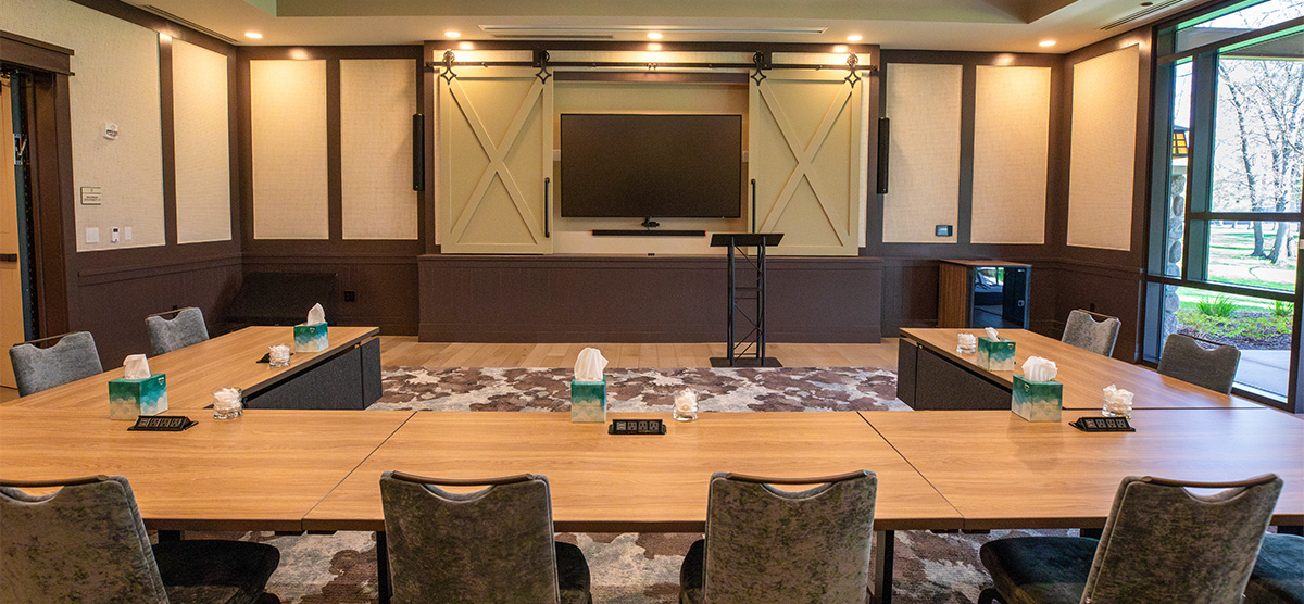 U-shaped table for meetings with a TV in a meeting room in The Inn at SentryWorld