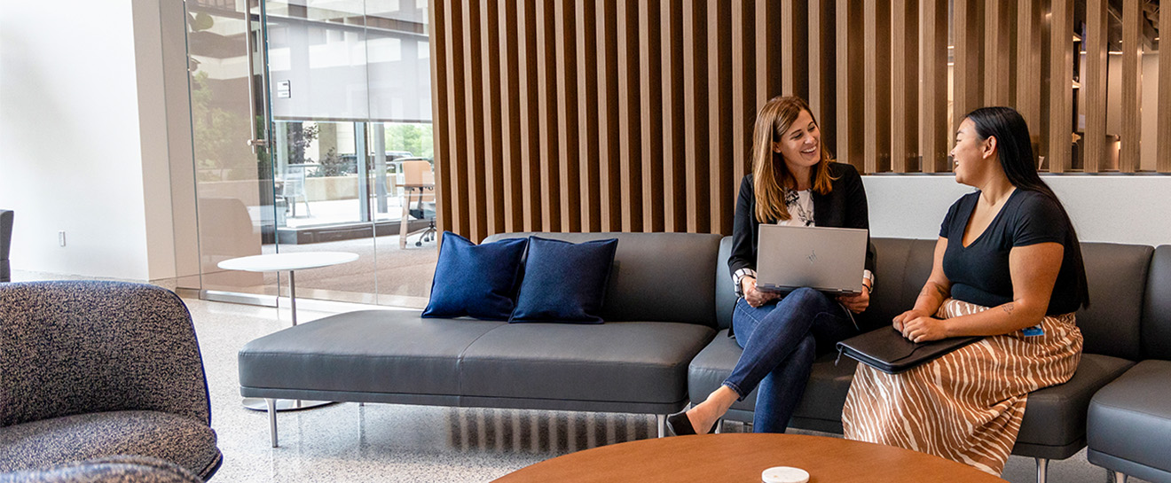 A mentor and an intern having a conversation at Sentry home office.