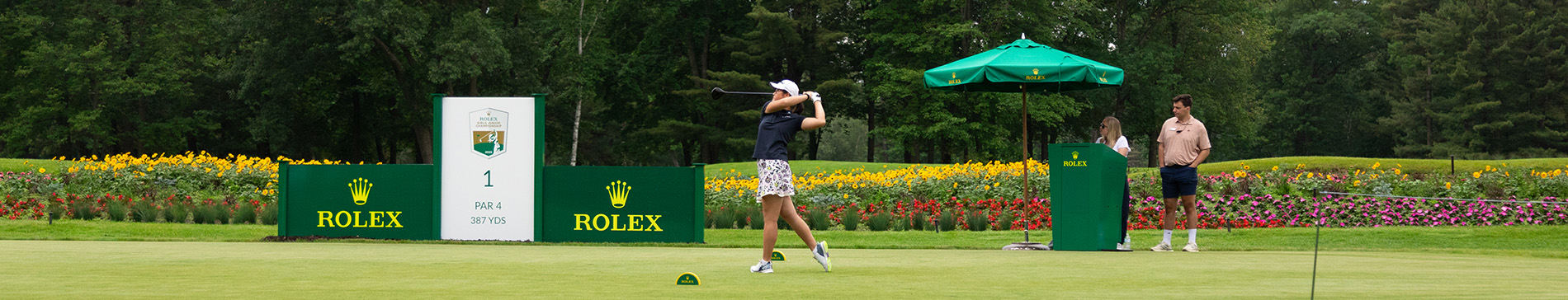 Junior girl teeing off on hole 1.