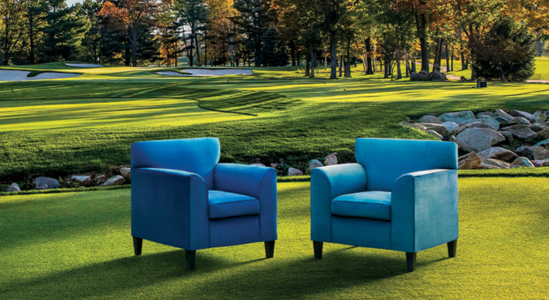 Two blue colored chairs on the SentryWorld golf course