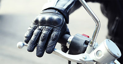 Motorcyclist wearing heated gloves