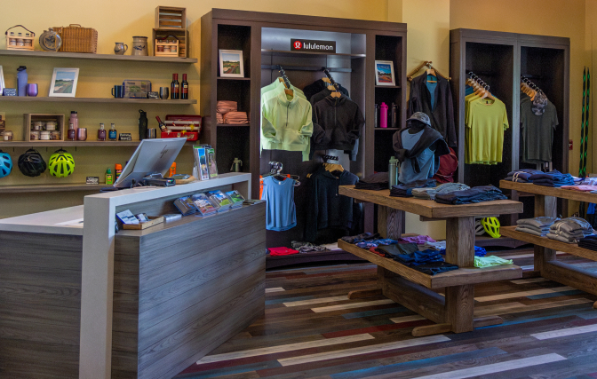Interior of the outfitter at The Inn with clothing displays, shelves of merchandise, and a checkout counter.