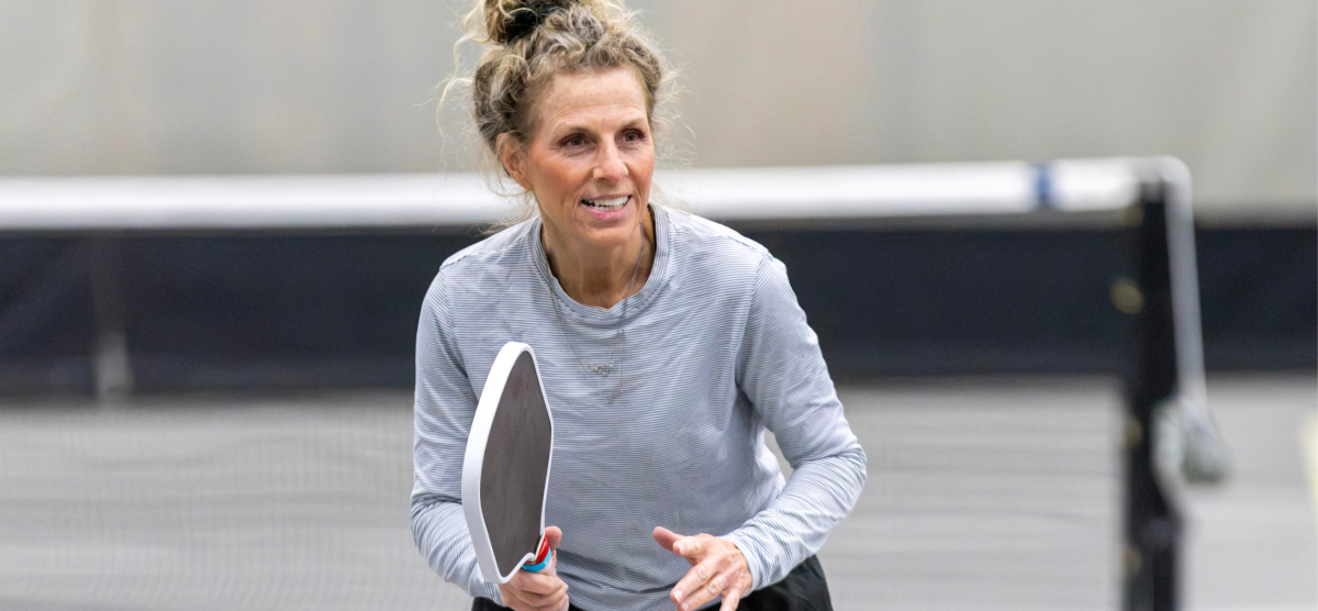 Female pickleball player in SentryWorld fieldhouse.