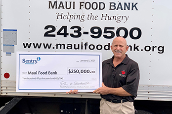 Sentry representative donates check to Maui food bank