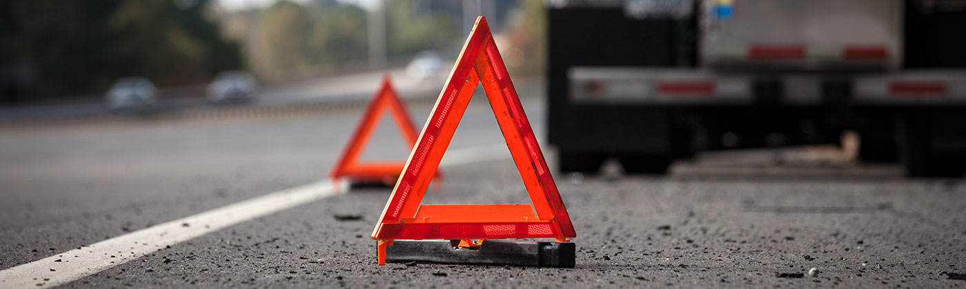 Two safety cones on road at accident scene