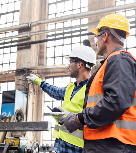 Two workers in safety gear on jobsite