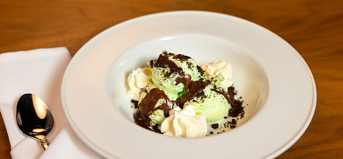 Grasshopper sundae with chocolate ganache, cookie crumble, and whipped cream. 