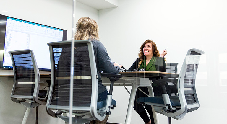 Two people sitting in a Sentry office having a conversation