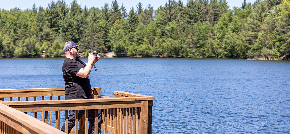 Person fishing off a dock in Stevens Point, Wisconsin