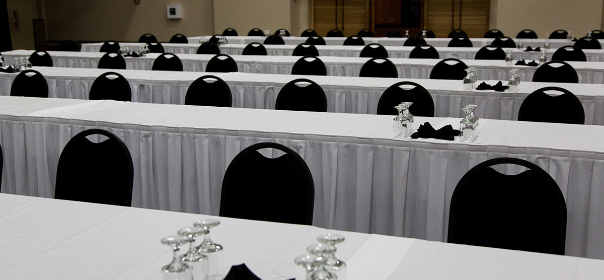 Long tables set for a meeting in the fieldhouse at SentryWorld