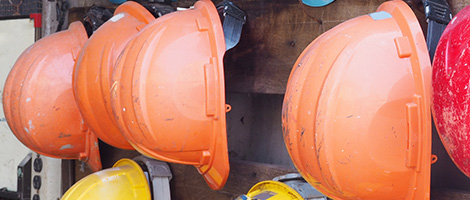 Hard hats hung up at construction jobsite.