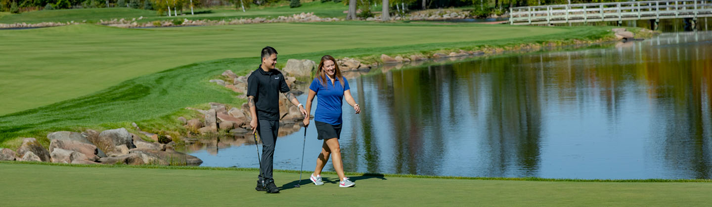 Golfers walking on golf course