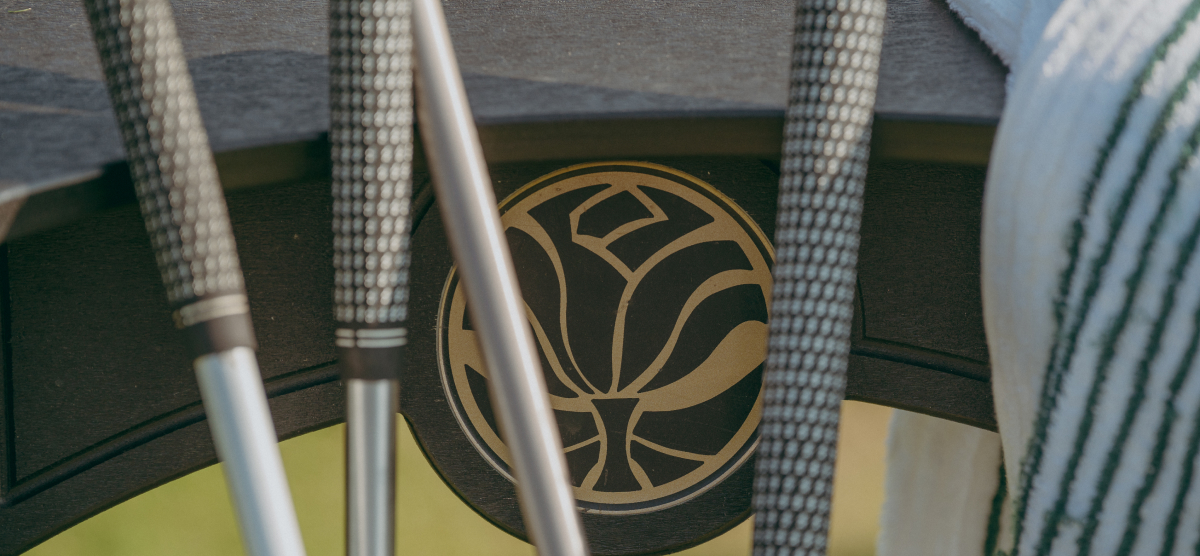 Golf clubs by the outdoor driving range. 