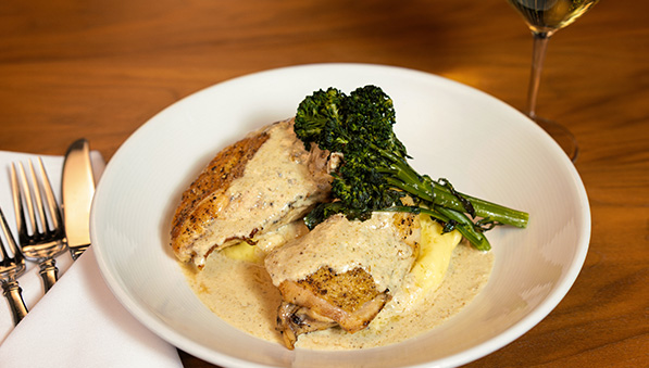 Oven-roasted half chicken with Yukon Gold puree, cream, and broccolini.