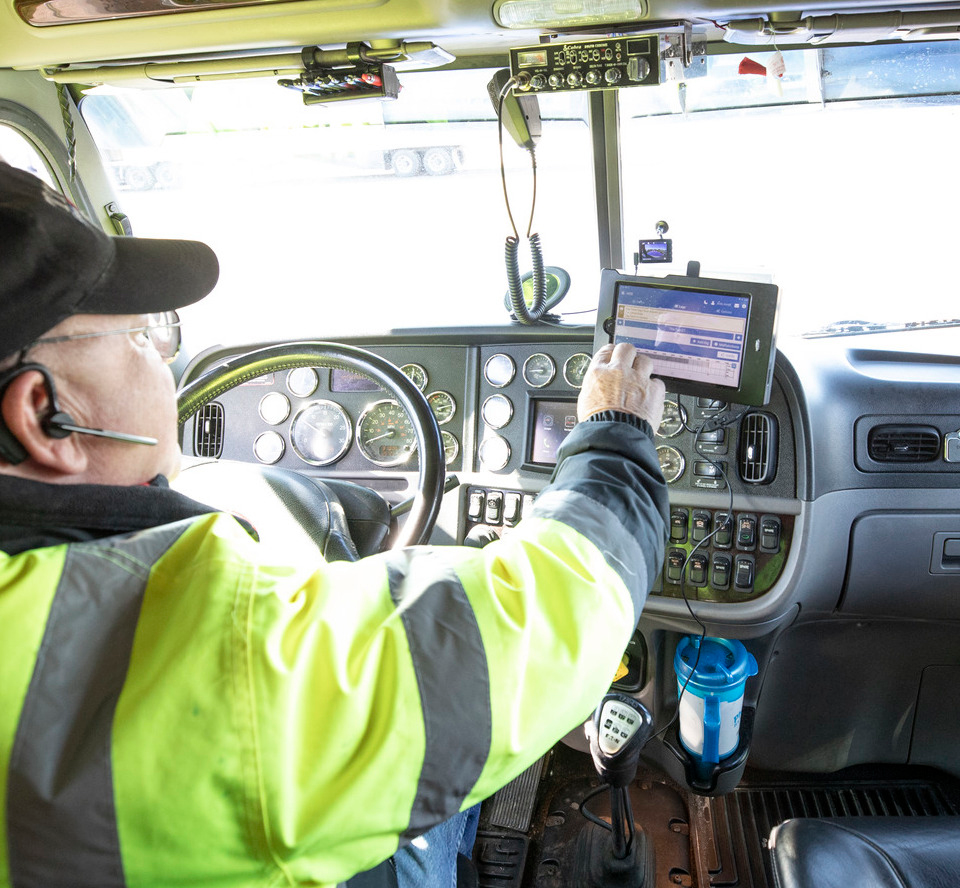 Driver entering information on a touchscreen.