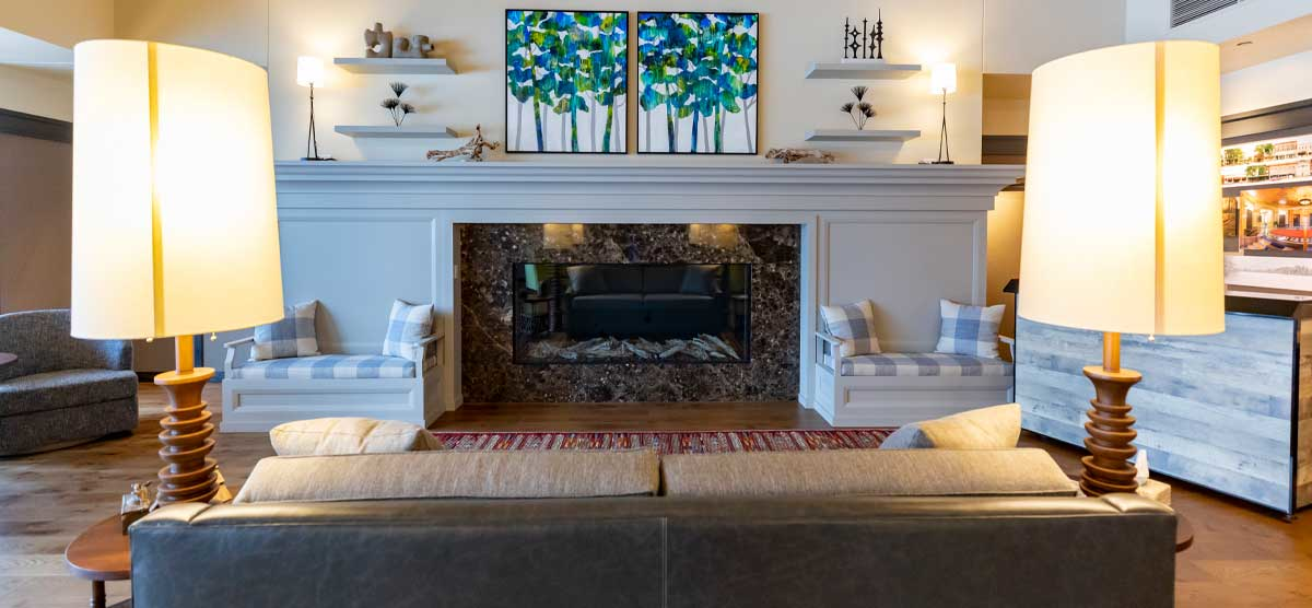 Couch and lamps facing the fireplace in the Executive Lounge