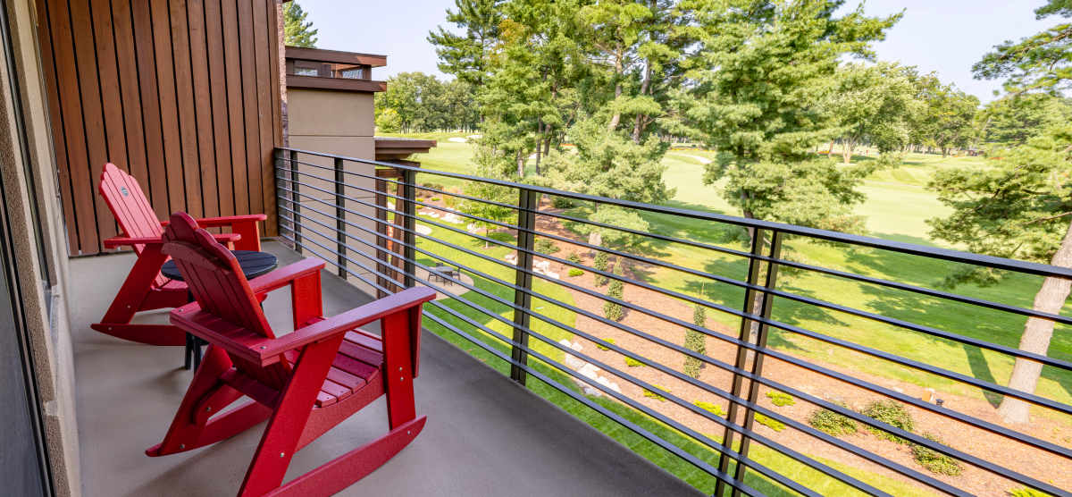 Two rocking chairs on an executive level balcony overlooking hole 18. 