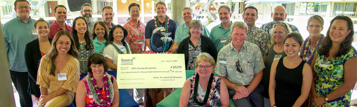 Sentry representatives gather around Sentry Tournament of Champions donation check