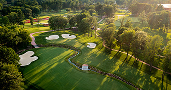 Aerial view of a fairway with sand traps and a water hazard on the SentryWorld golf course