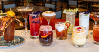Variety of cocktails on a marble bar countertop. 
