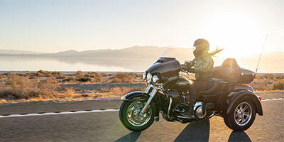 Female motorcyclist riding a trike bike