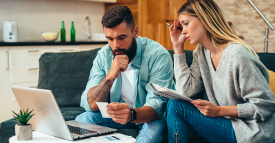 Overwhelmed couple on laptop working on their budget