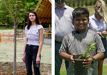 Two people standing during the tree planting ceremony