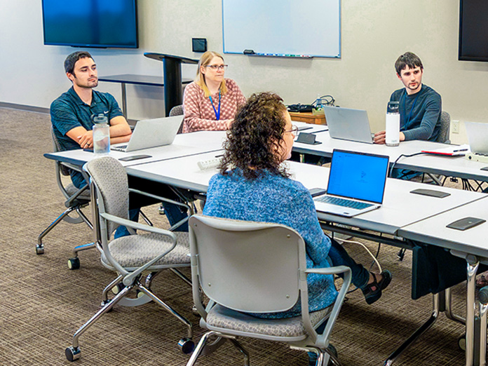 Actuary associates in a meeting at Sentry home office in Stevens Point, Wisconsin.